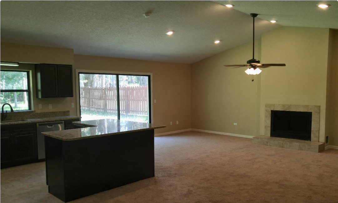 Pine Needles kitchen and fireplace before